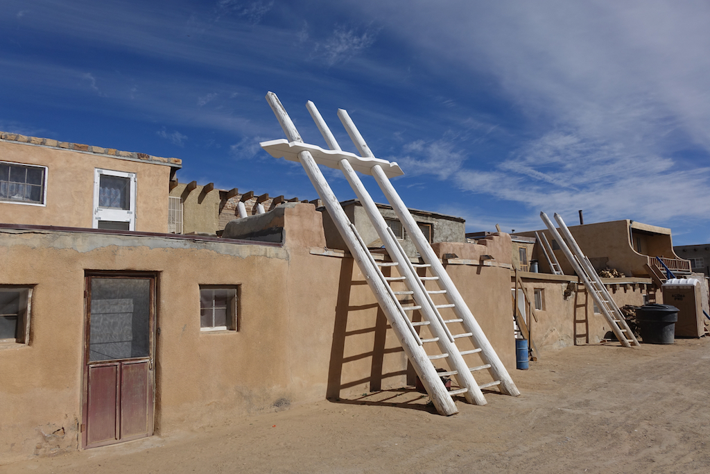 White ladders up the side of the smooth exteriors of the homes.