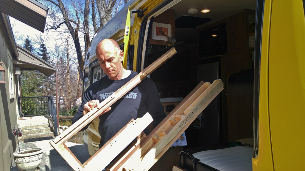 James carrying wood out of Winnebago Travato.