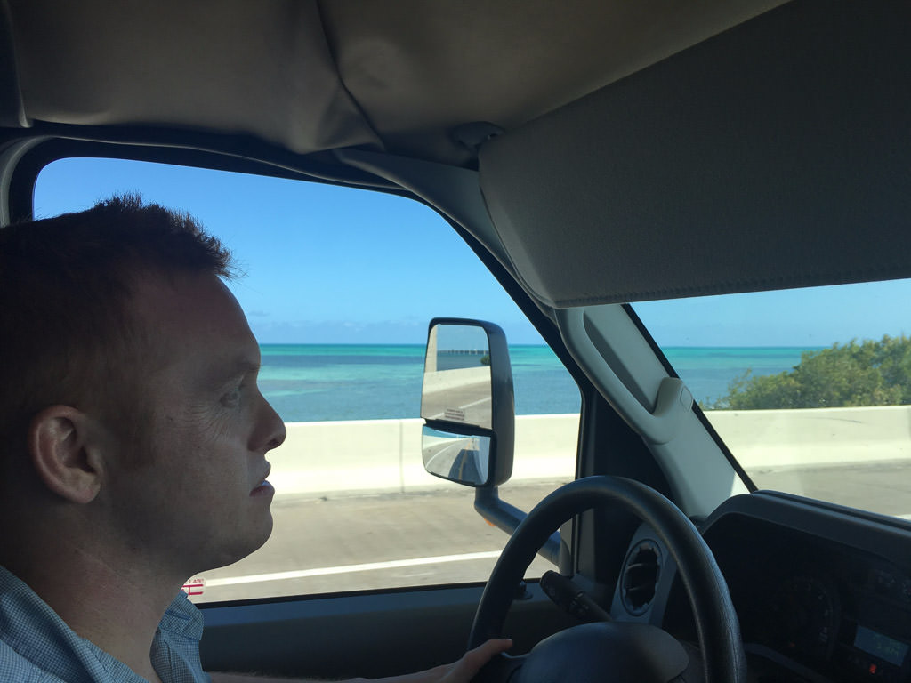 Heath driving RV with water out the driver side window.