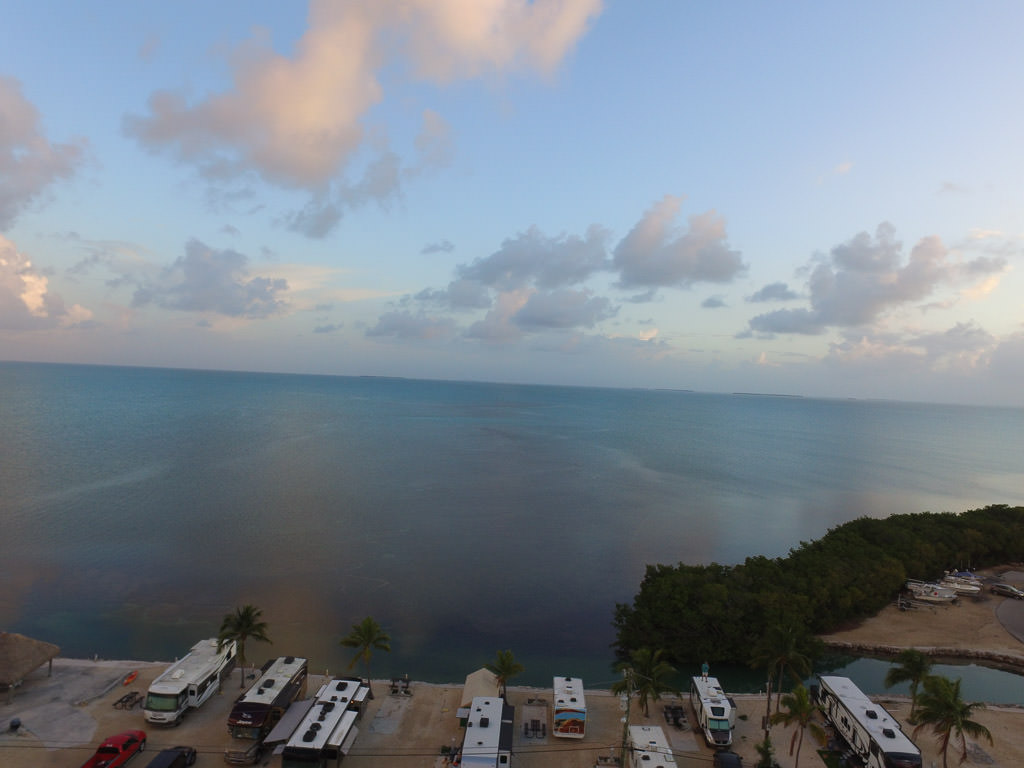 RVs parked at campsites right next to the water.