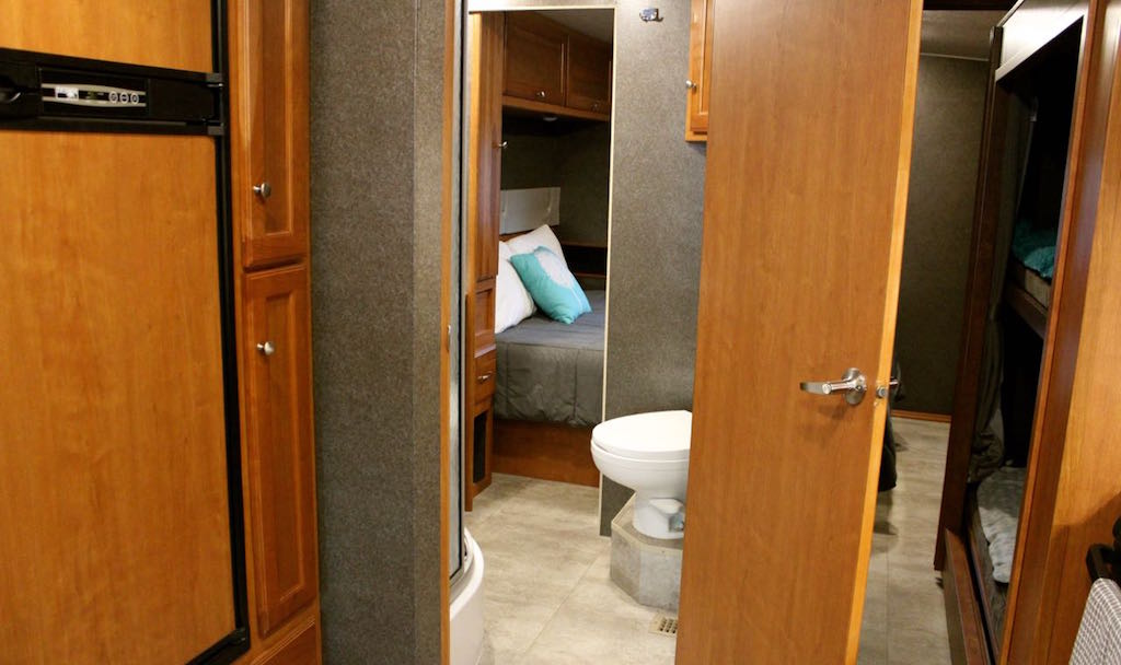 Bathroom of Winnebago Vista with doors opening to back bedroom.
