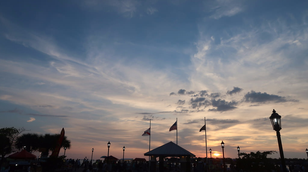 Pier along the water with a beautiful sunset.