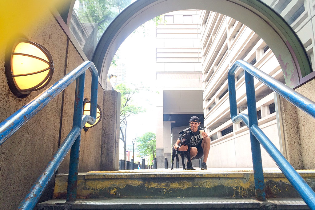 Jordan leaning down next to Ella at the top of a staircase.
