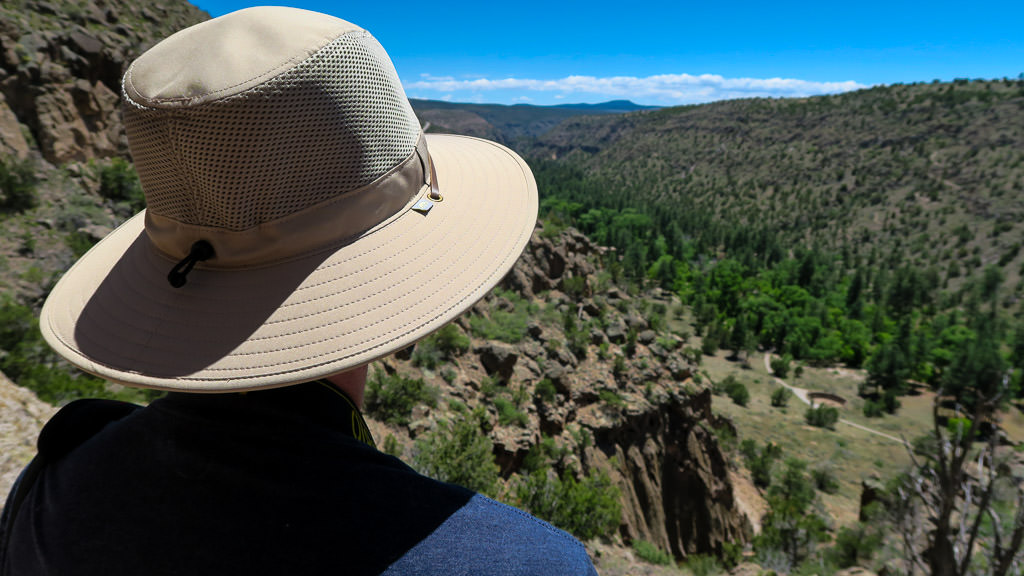 Person looking out over tree covered hillsides.