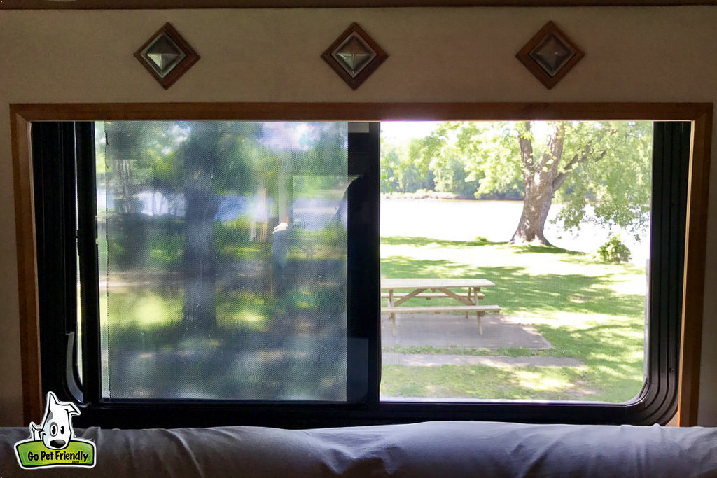 Picnic table out the open window of the RV.