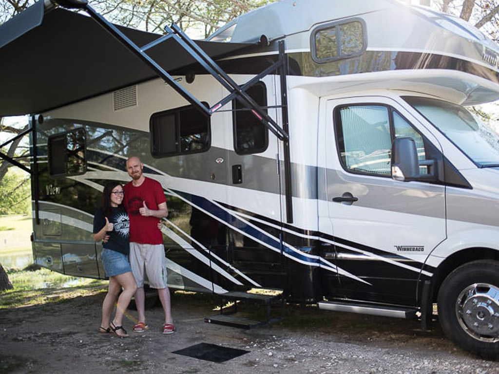 Couple standing in front of Winnebago View.