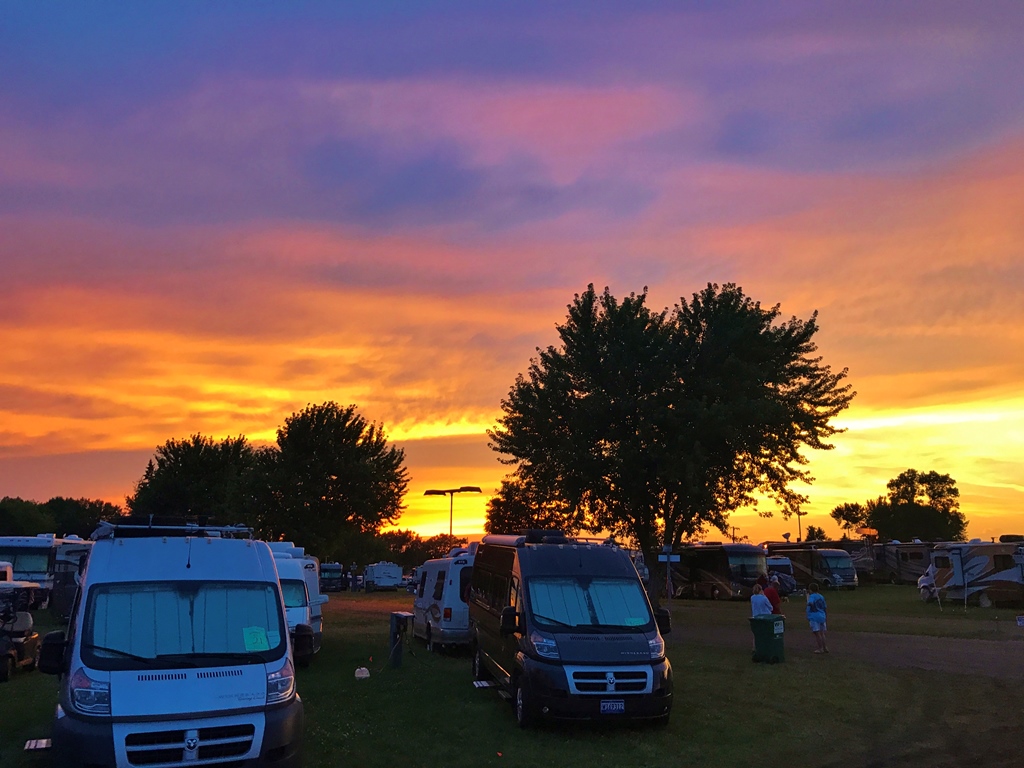 Beautiful sunset above rows of Winnebago motorhomes.