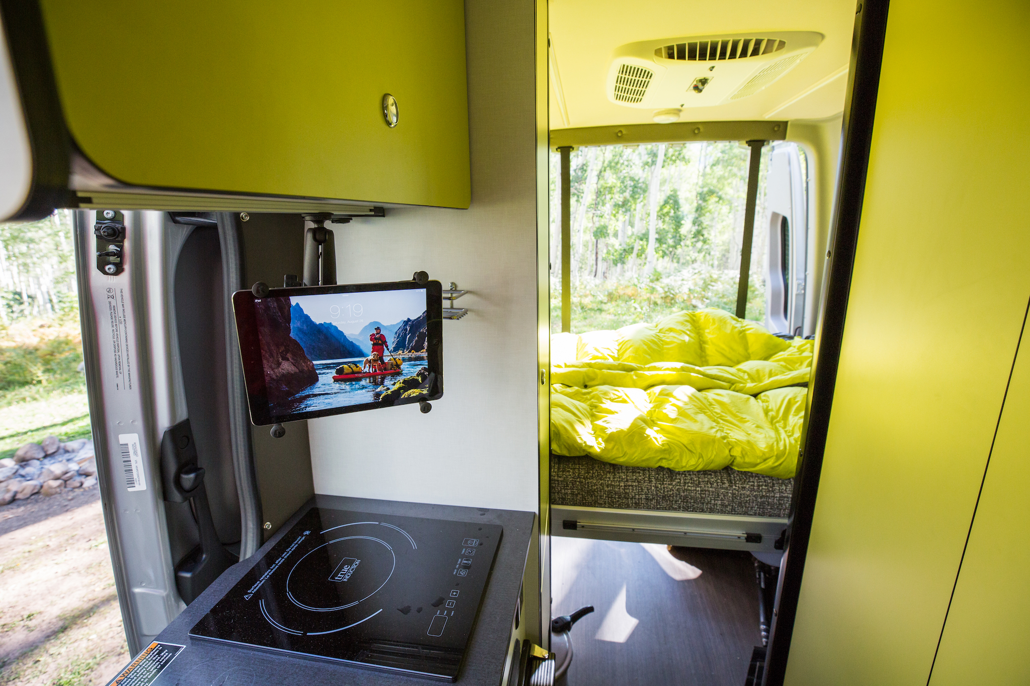 Kitchenette area and bed in Winnebago Revel.
