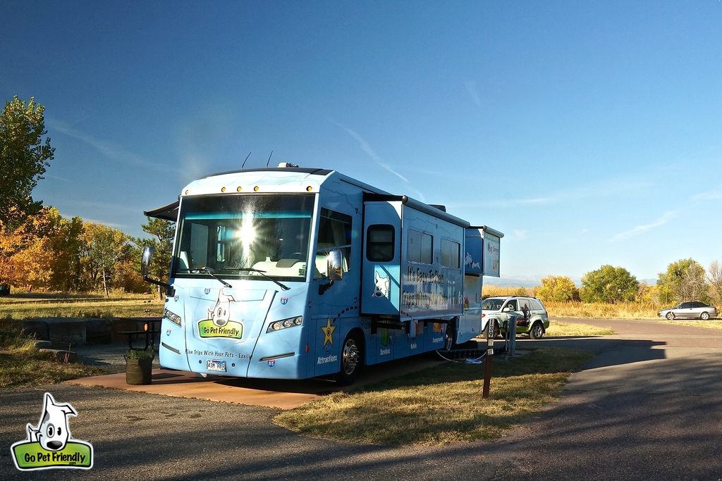GoPetFriendly rv parked at campsite with wrapped tow car behind it