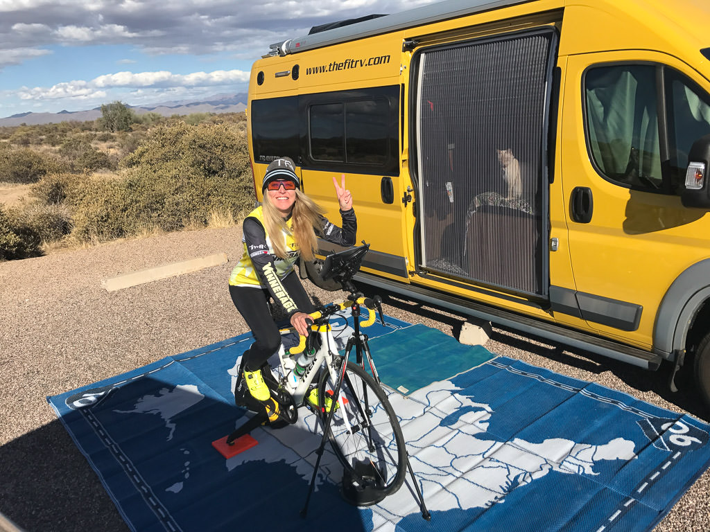 Stef on bike outside their Winnebago Travato