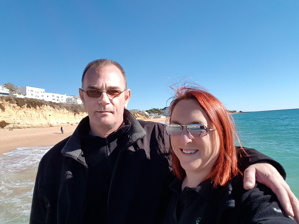 Couple standing in the water on a beach