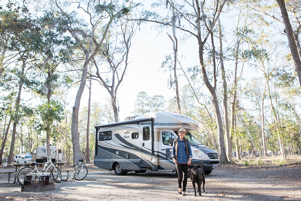 Brittany and Ella walking away from Winnebago View parked at campsite in Fort McAllister State Park 
