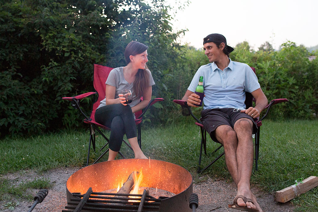 Brittany and Jordan sitting in camping chairs by the fire