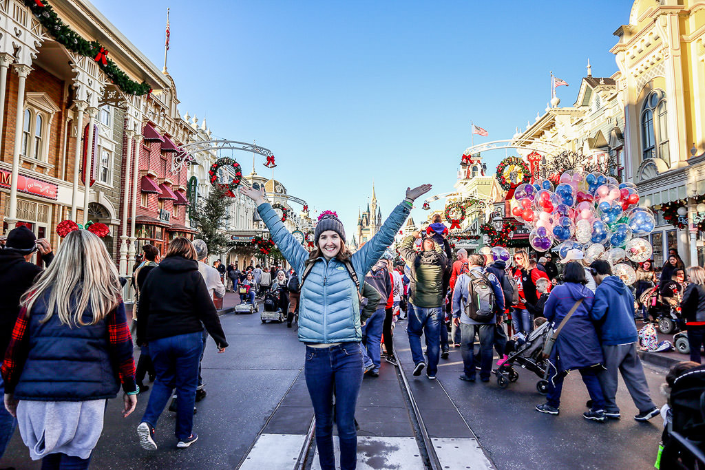 Katherine standing in middle of a busy street in Disney World