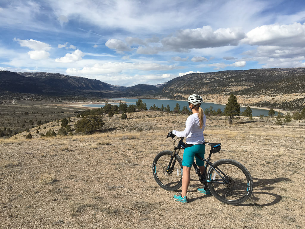 Stef standing by bike near water