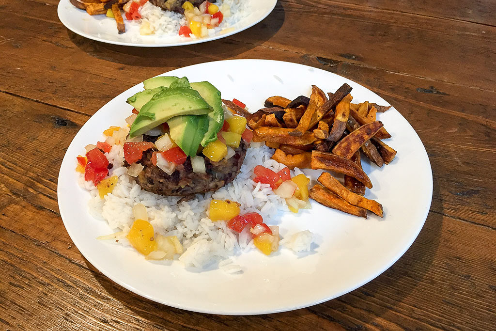 Black bean burger on cilantro-lime rice topped with fresh mango salsa & avocado.