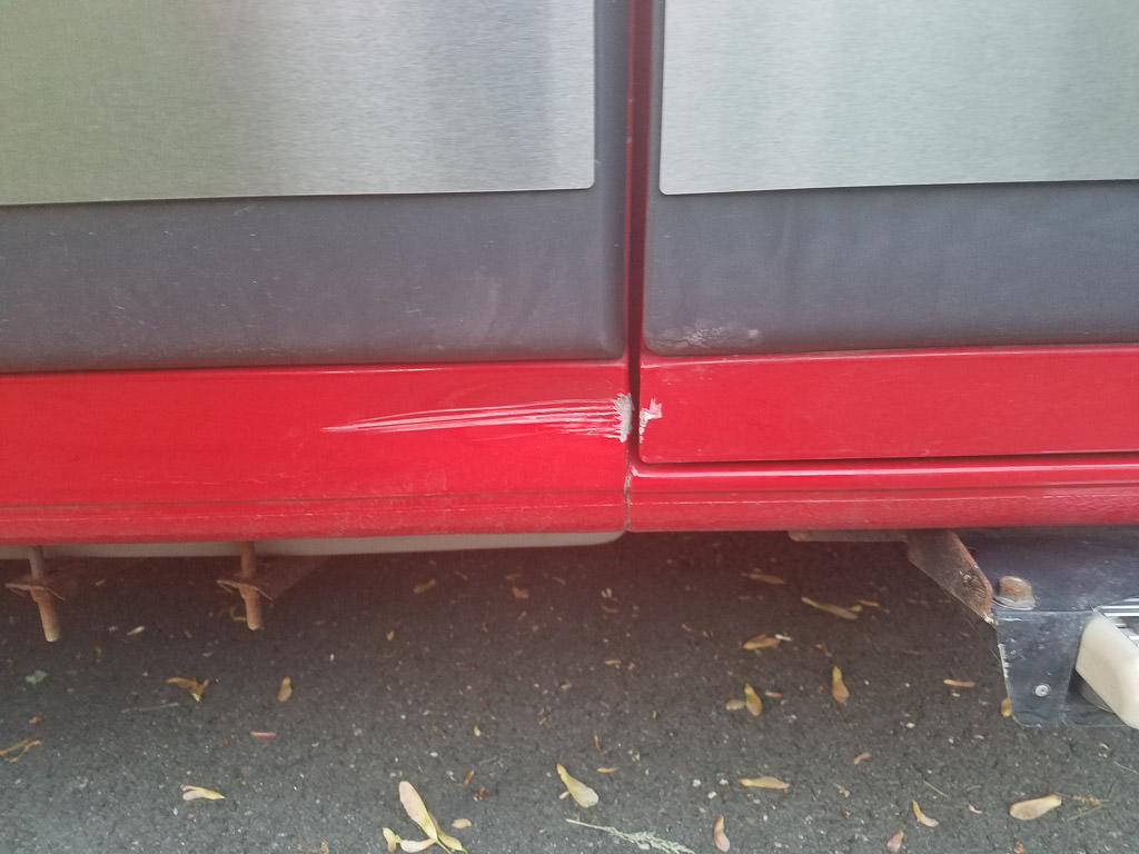 Scratch on the side of Travato from rock