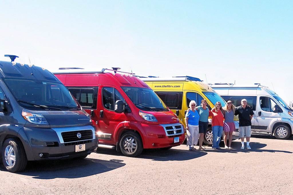 Linda Calabrese, Linda McSweeney, Kate Mullen, Ron Merritt, and Bob Jeselnik standing in front of their Winnebago B vans