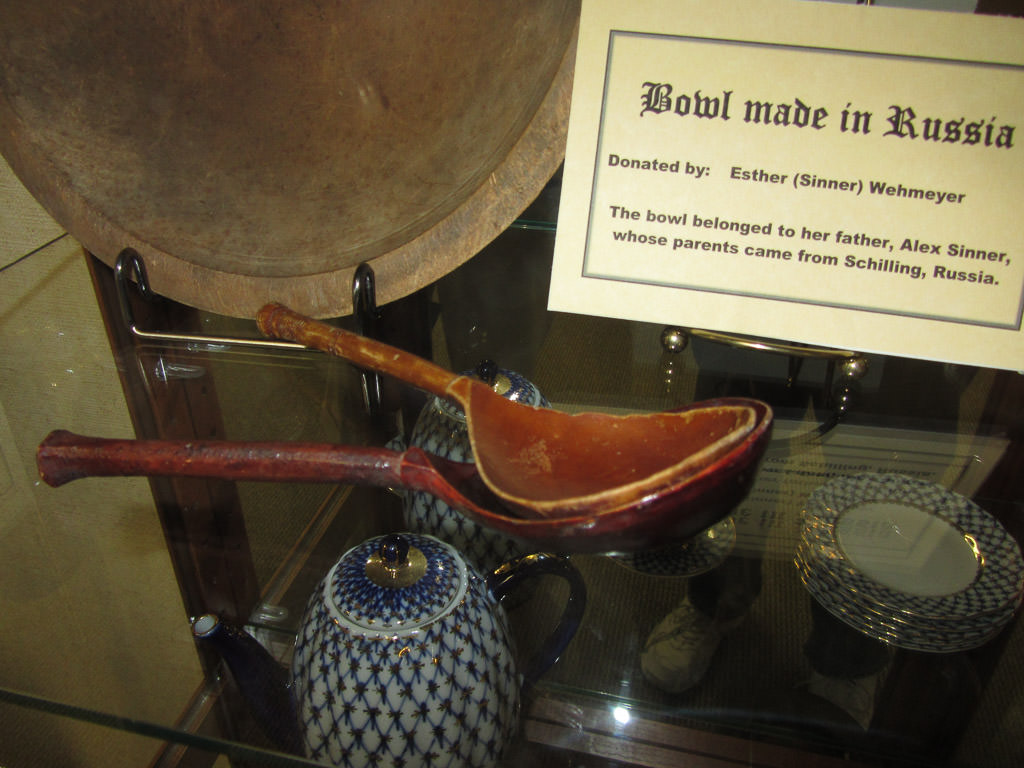 Old wooden spoons in display case.