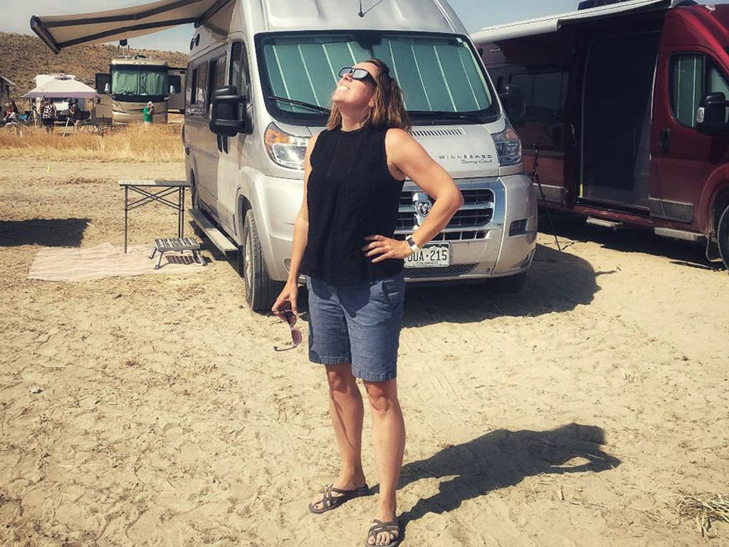 Young woman enjoying the sunshine at her harvest host camping spot
