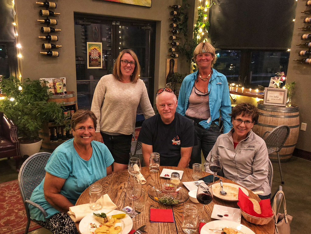 Group posing at dinner table in nice restaurant.