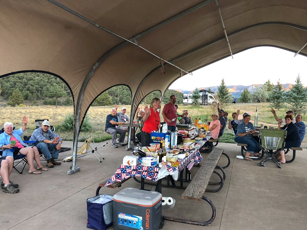 WinnieB group gathered under a large tent.