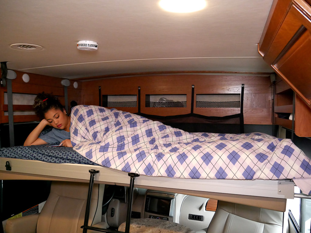 Kenny and Sabrina's niece lounging in the drop-down bunk at the front of the unit.