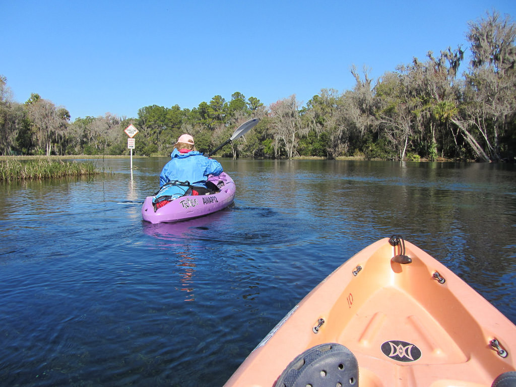 Two people kayaking down the springs.