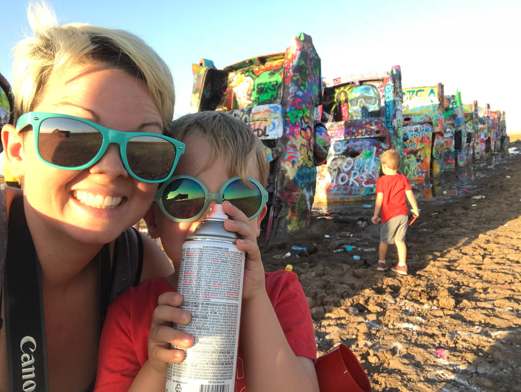 Jess and the boys with spray painted items in the background
