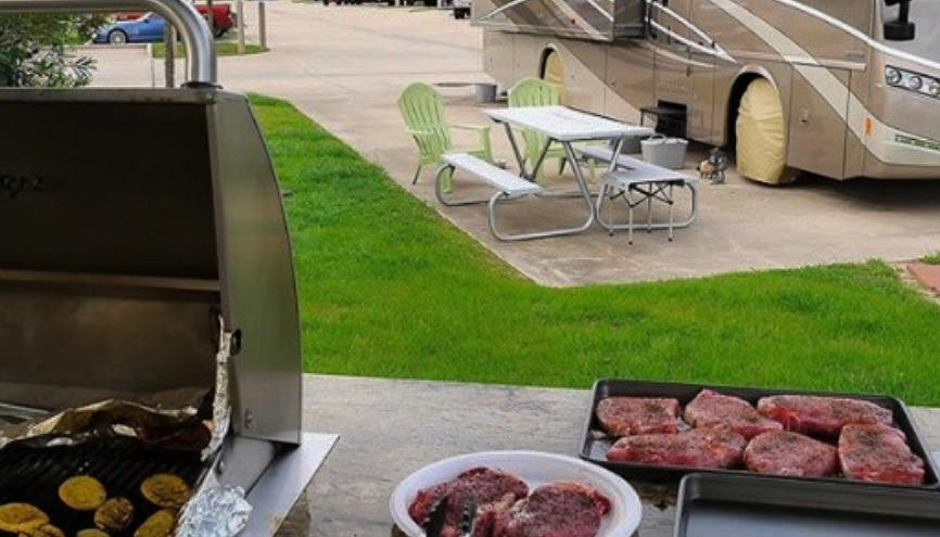 Steaks on counter outside ready to be grilled 