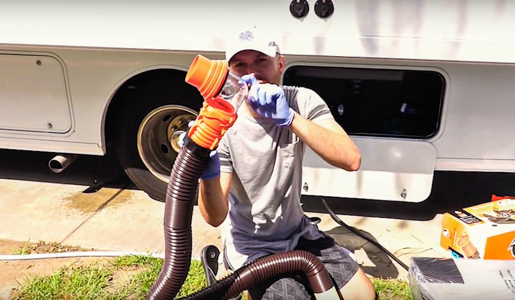 Young man showing the sewer hose support