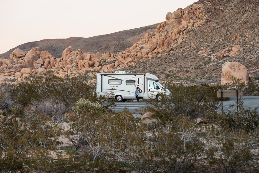 Winnebago Trend parked at the base of a rocky hillside.