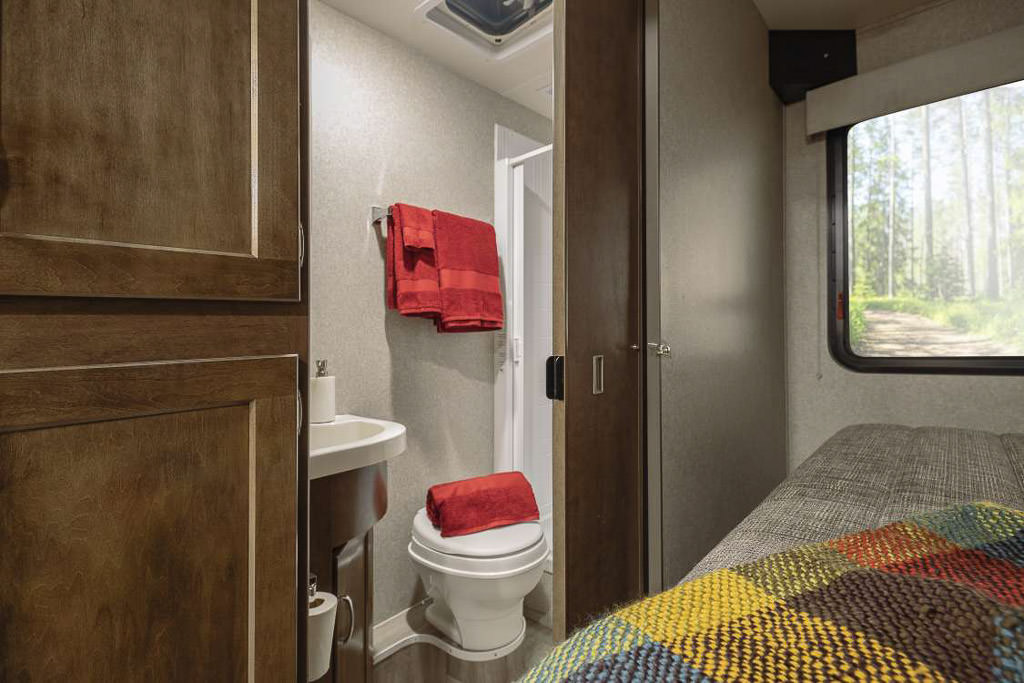 Winnebago Vita bathroom next to the bed.