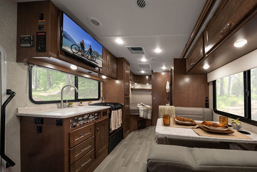 Winnebago Vita interior kitchen, dinette, and bed. 