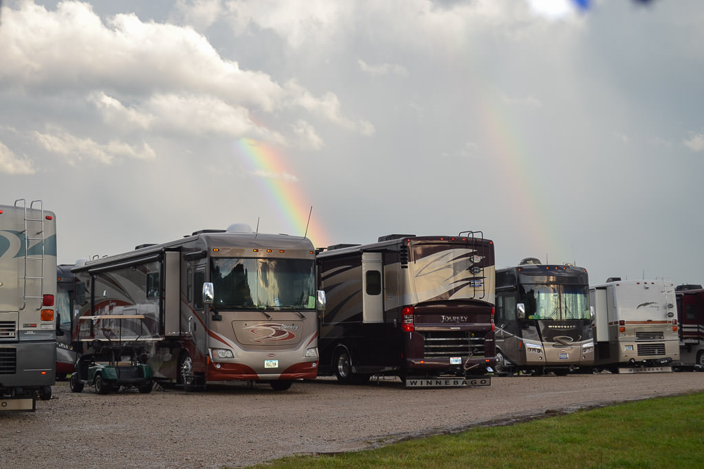 Double rainbow over row of Winnebago motorhomes