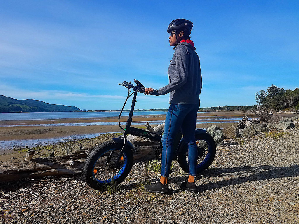 Woman enjoys ocean views from her electric bicycle