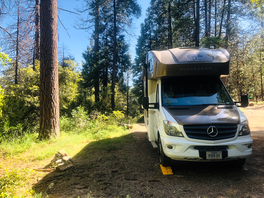 Winnebago View parked in tree filled campground.