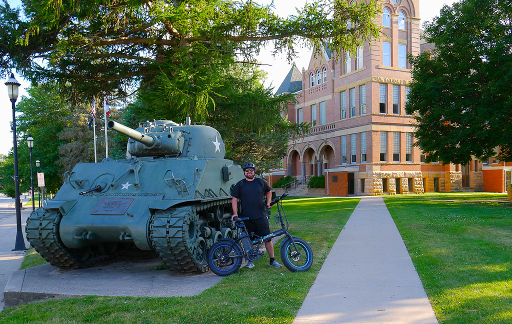 Man posing with his electric folding bike 