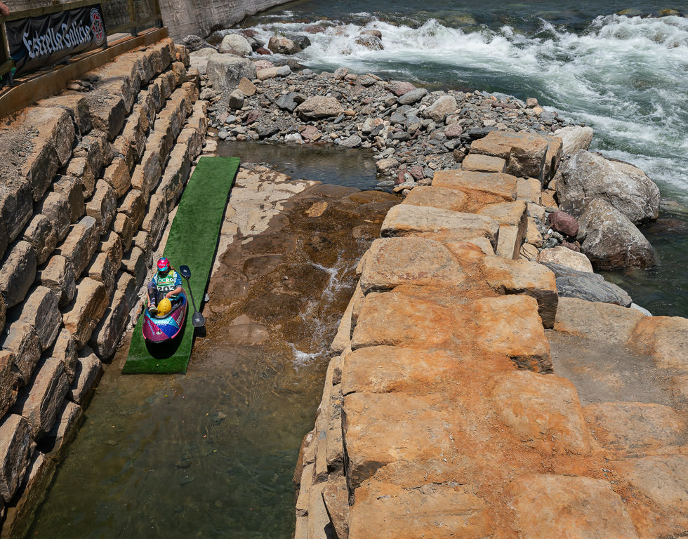 Kayaker on landing about to head in to the water.