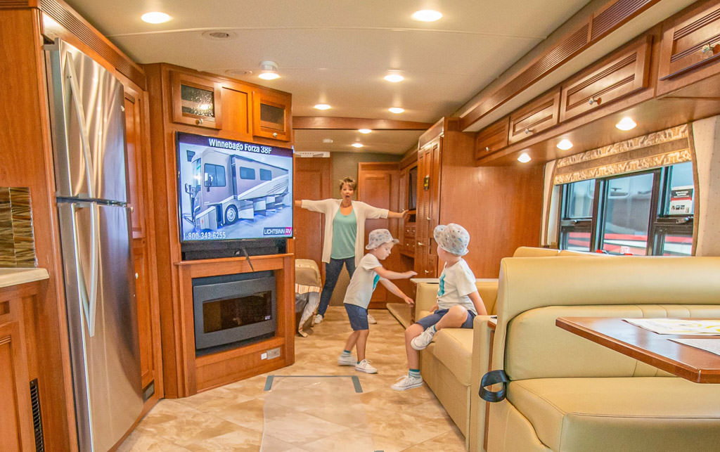 Jess and the boys in a Winnebago Forza at the product display
