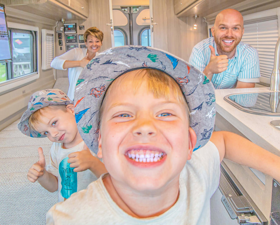 Nic, Jess and the boys in a motorhome in the Winnebago product display