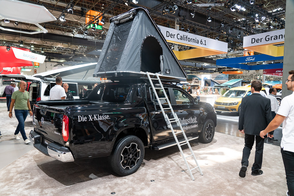 Pickup with tent on top of roof.