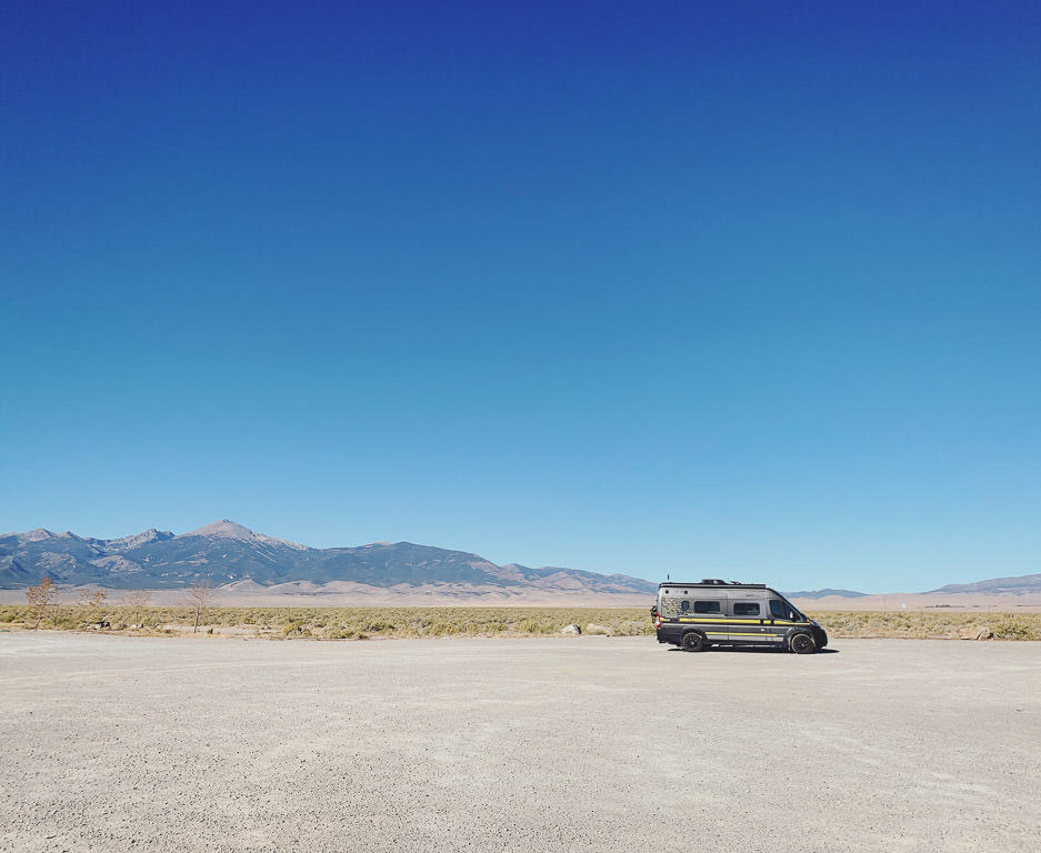 Winnebago Limited Edition National Park Foundation Travato parked with moutains in the background.